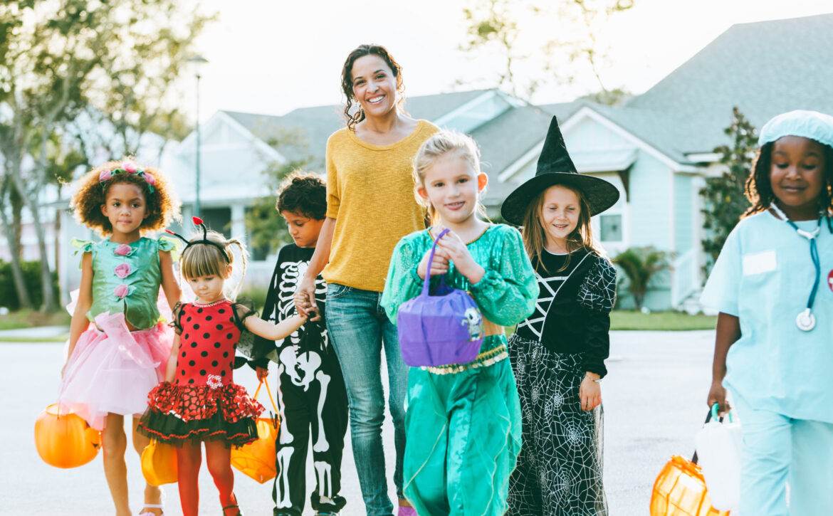 Woman With Group Of Children On Halloween