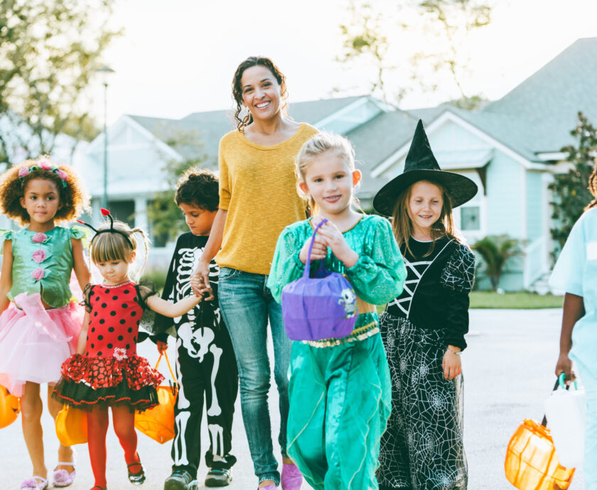 Woman With Group Of Children On Halloween
