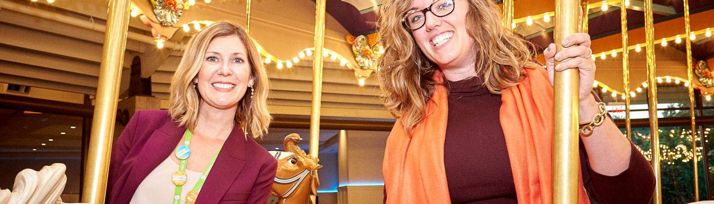 two women on carousel