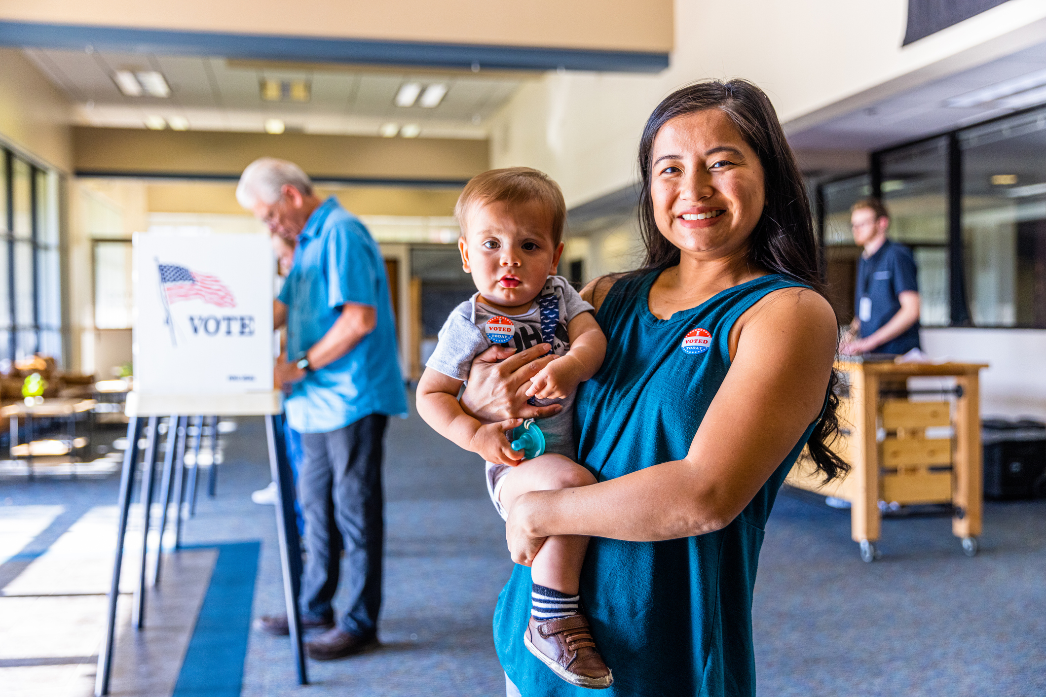 Filipino Woman And Her Baby Boy After Voting In An American Election