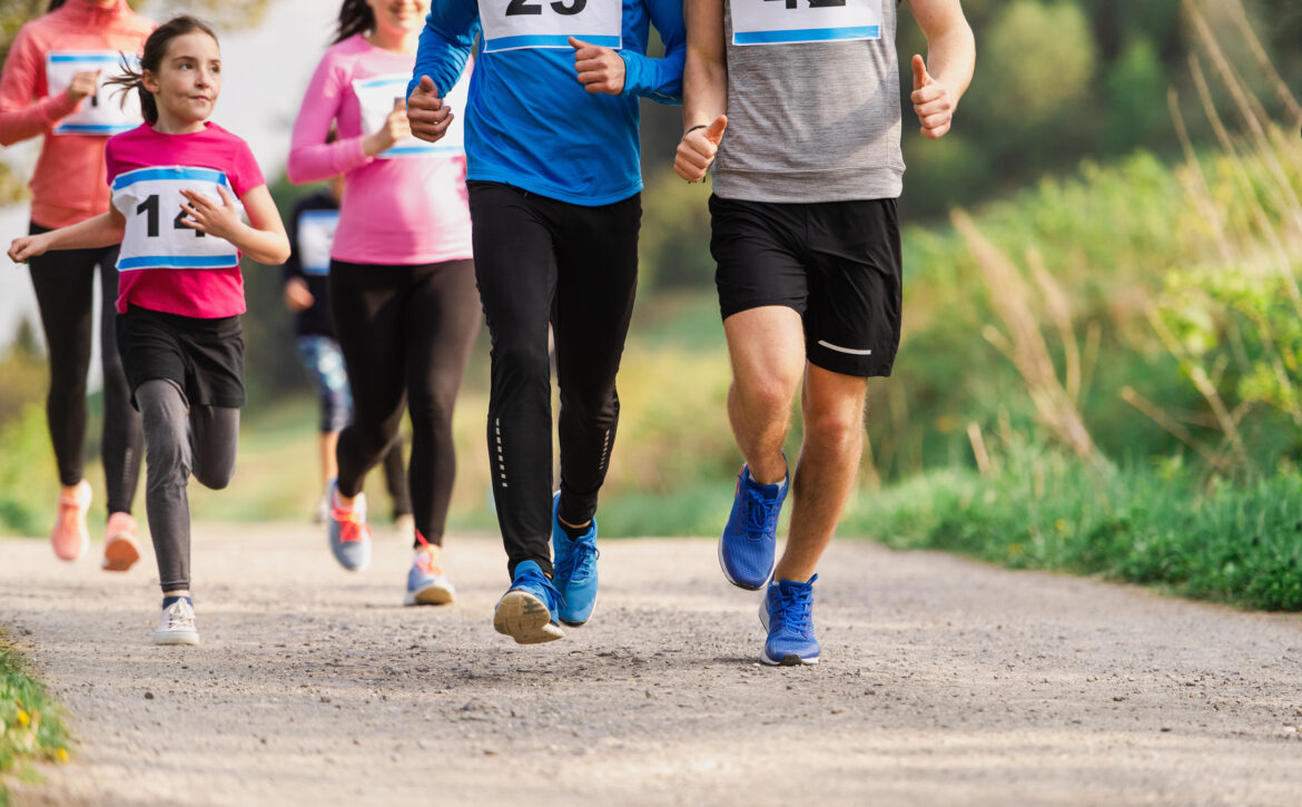 Midsection Of Large Group Of People Running A Race Competition In Nature.