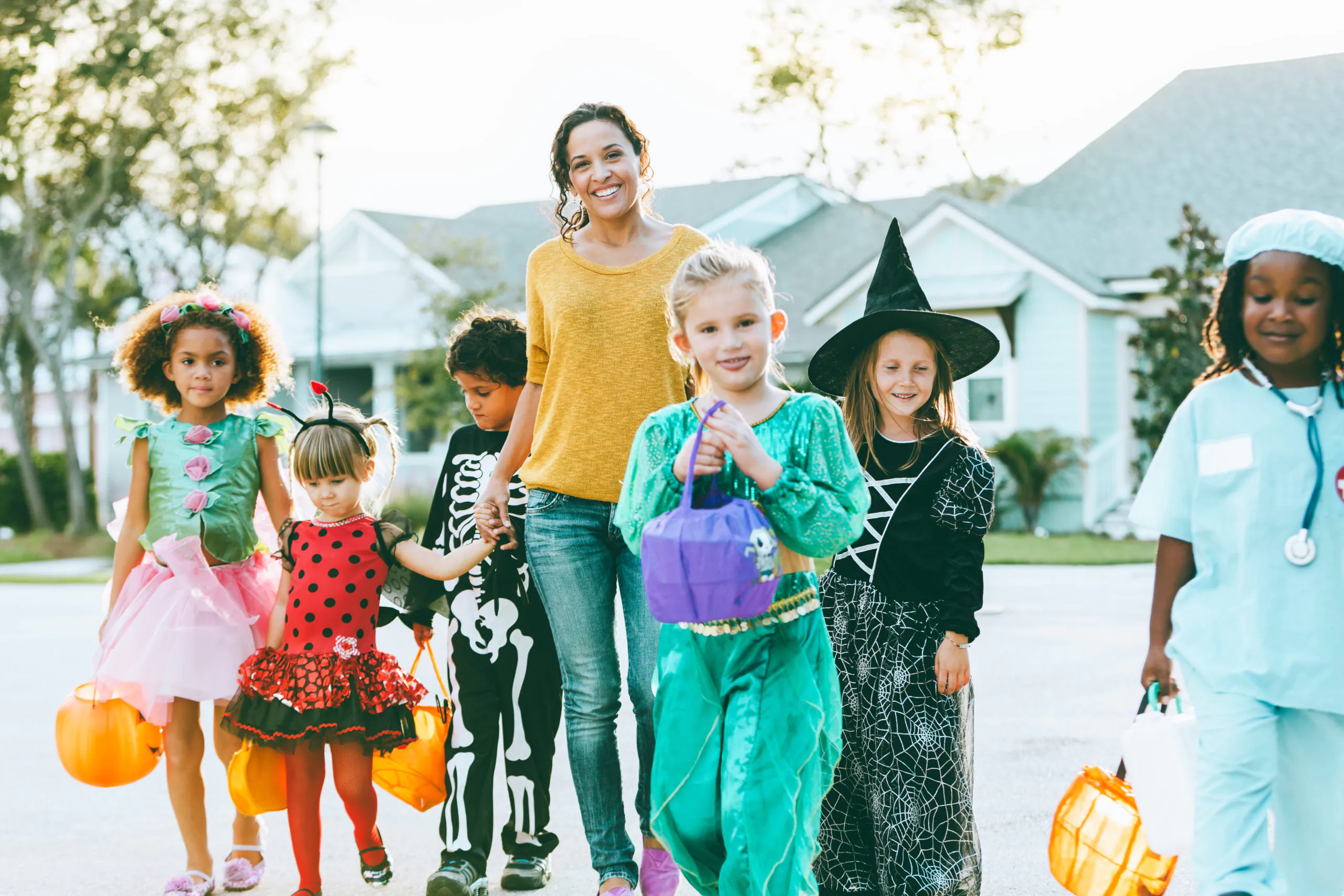 Woman With Group Of Children On Halloween