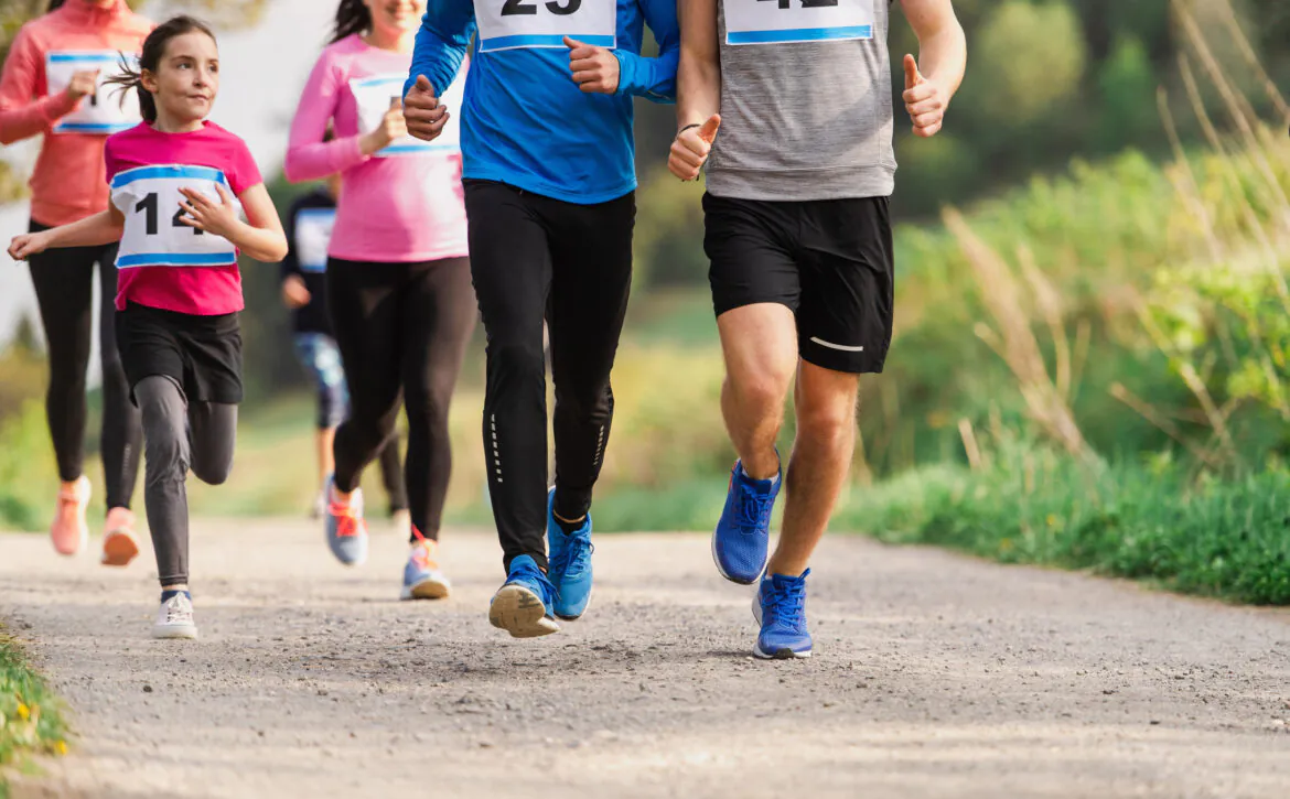 Midsection Of Large Group Of People Running A Race Competition In Nature.