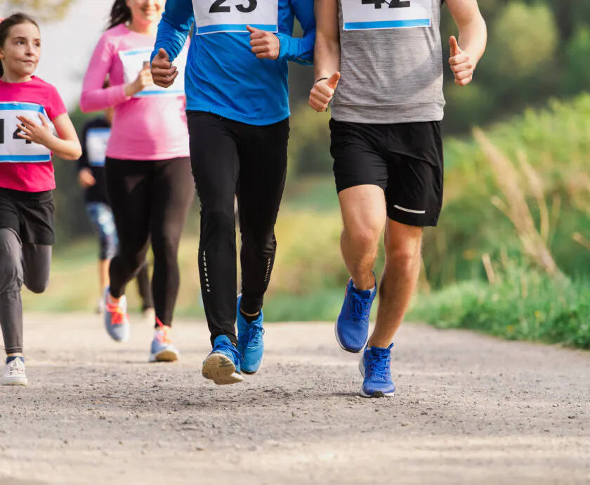 Midsection Of Large Group Of People Running A Race Competition In Nature.